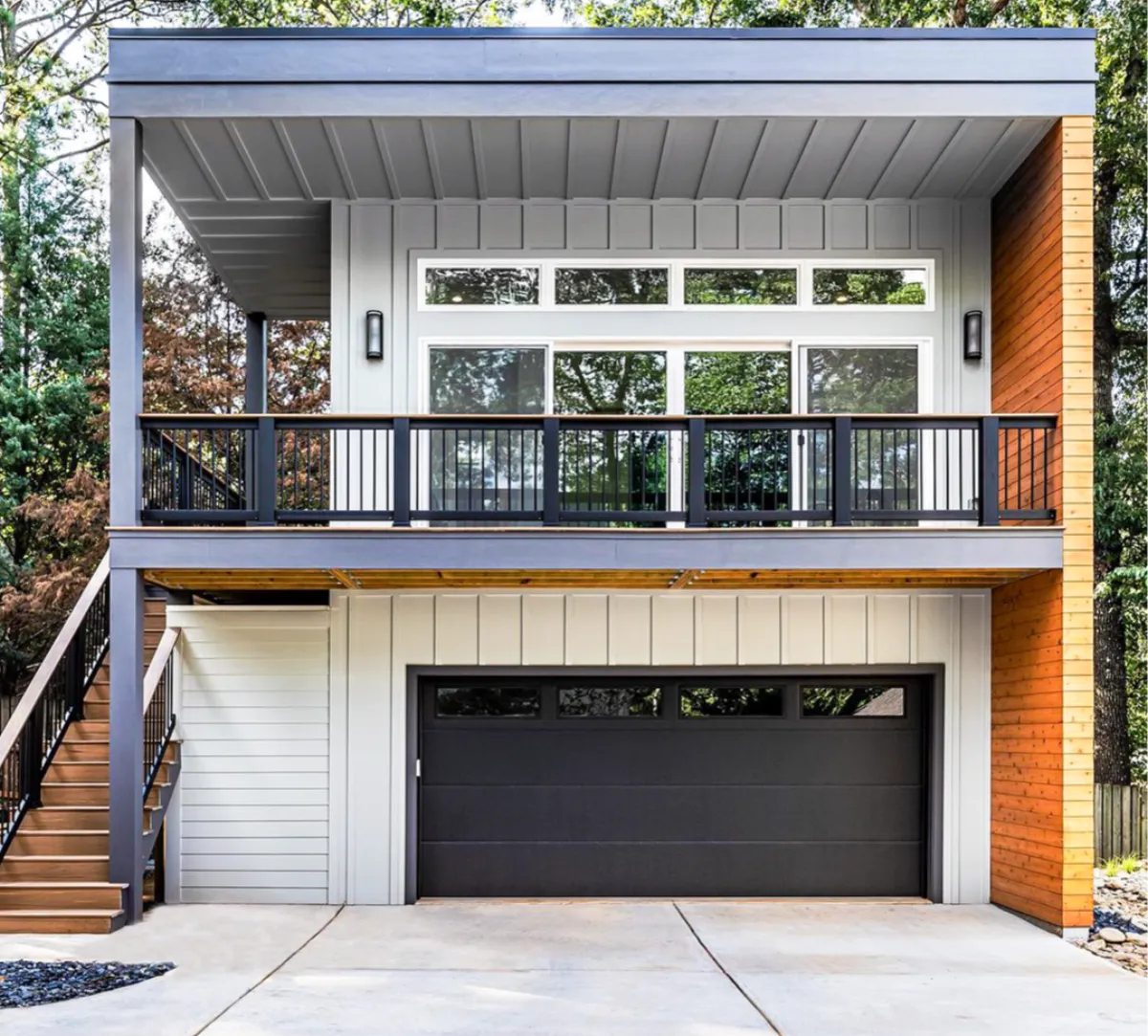 Modern black flush panel garage door on a contemporary home