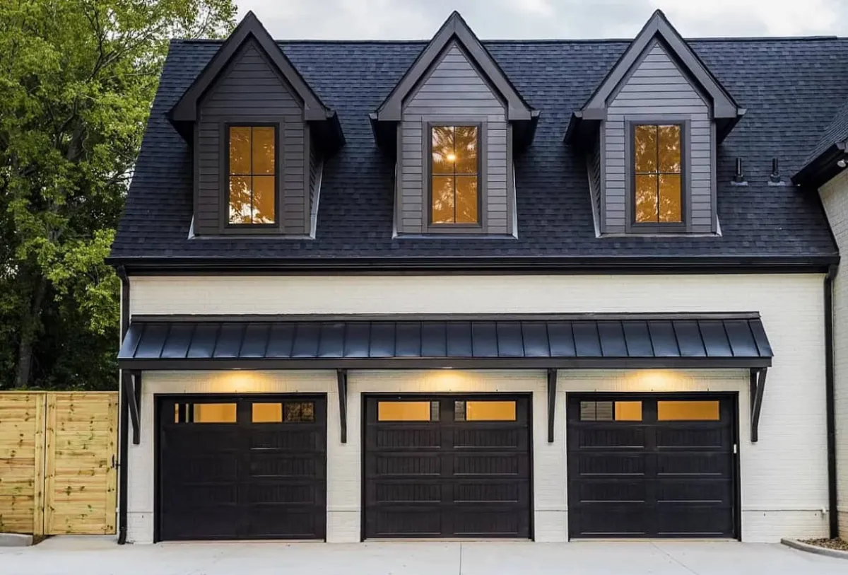 Black stamped carriage house doors on a two-car garage